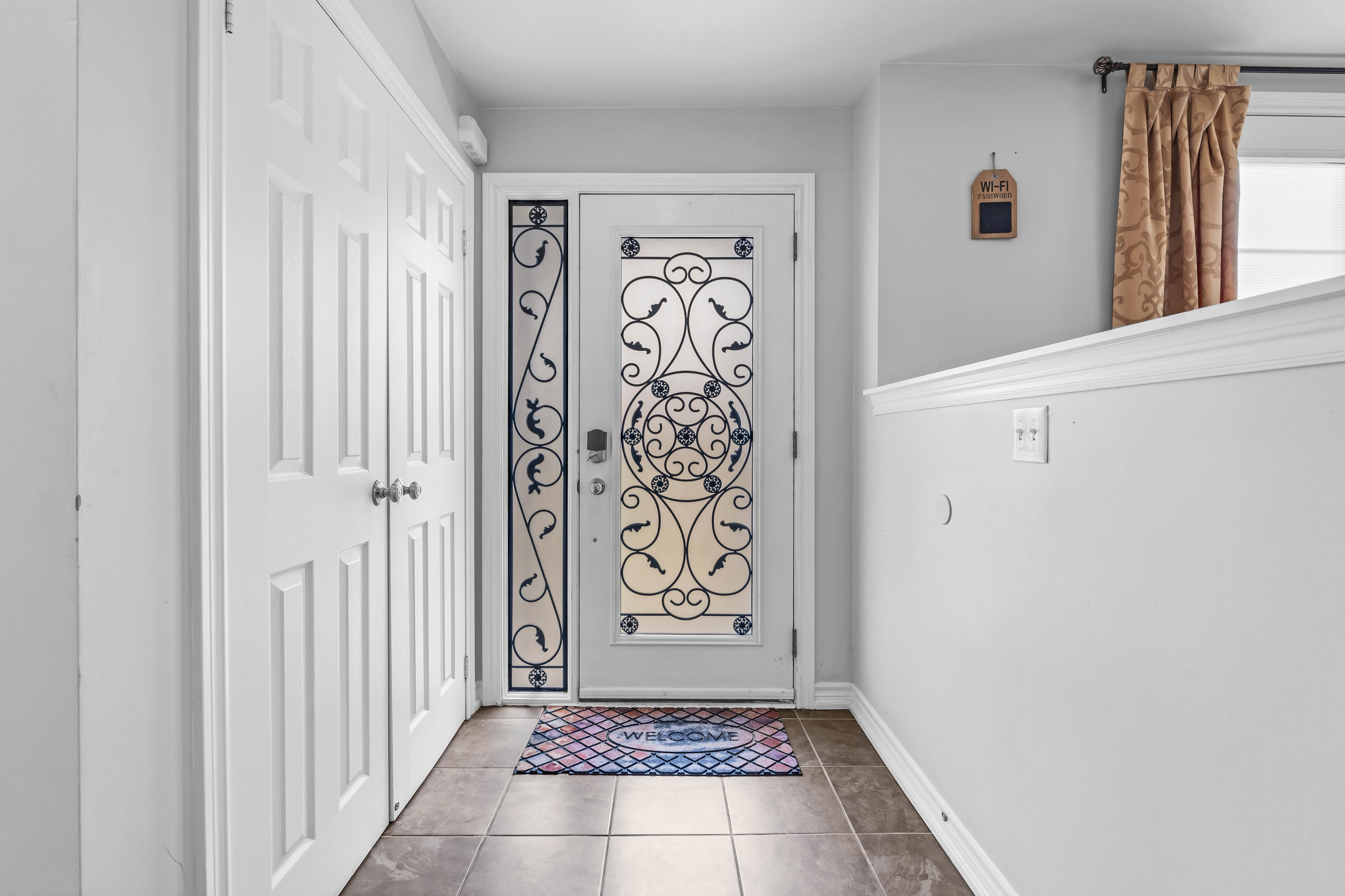 Foyer entrance with decorative door
