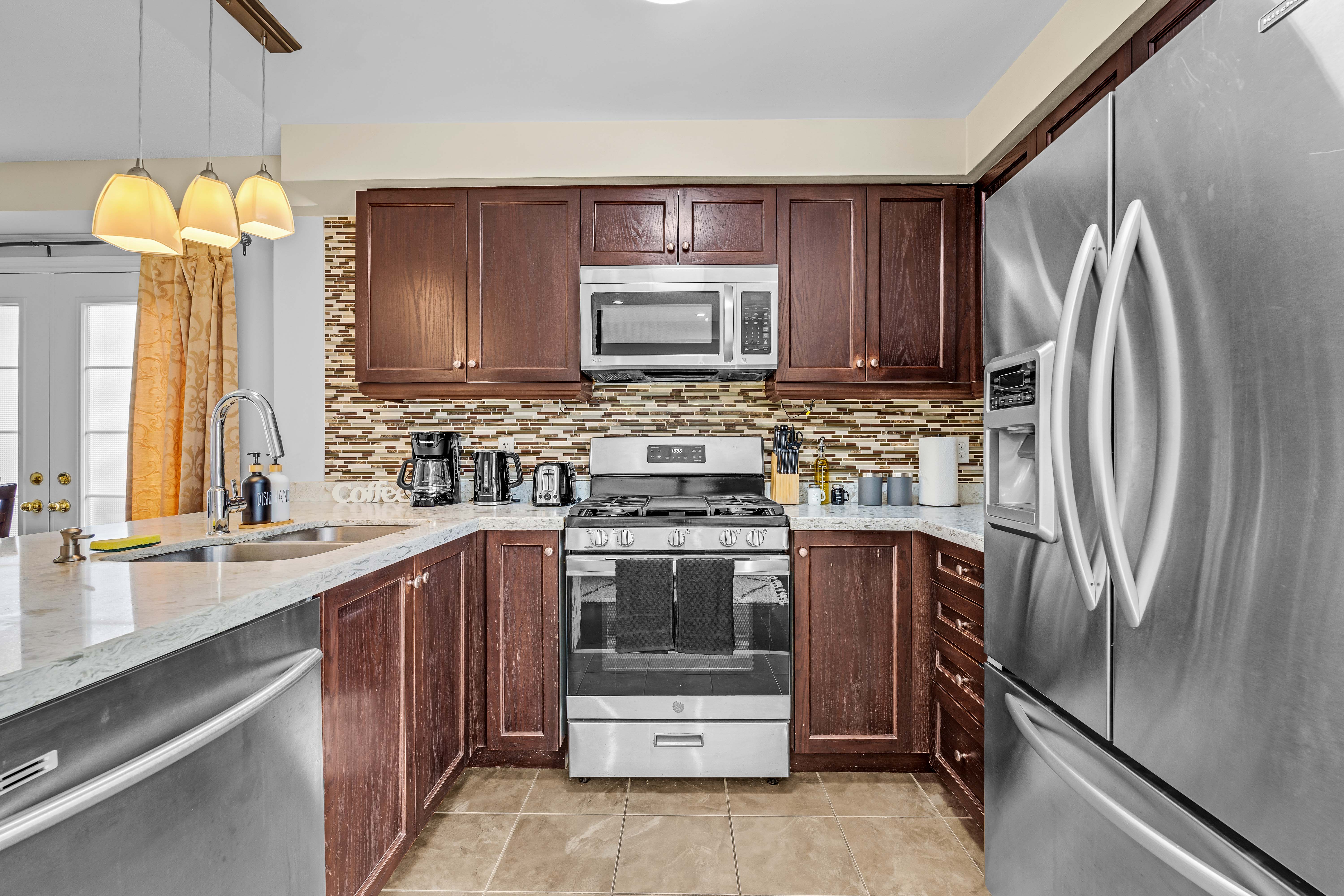 Updated kitchen with dark cabinetry and stainless steel