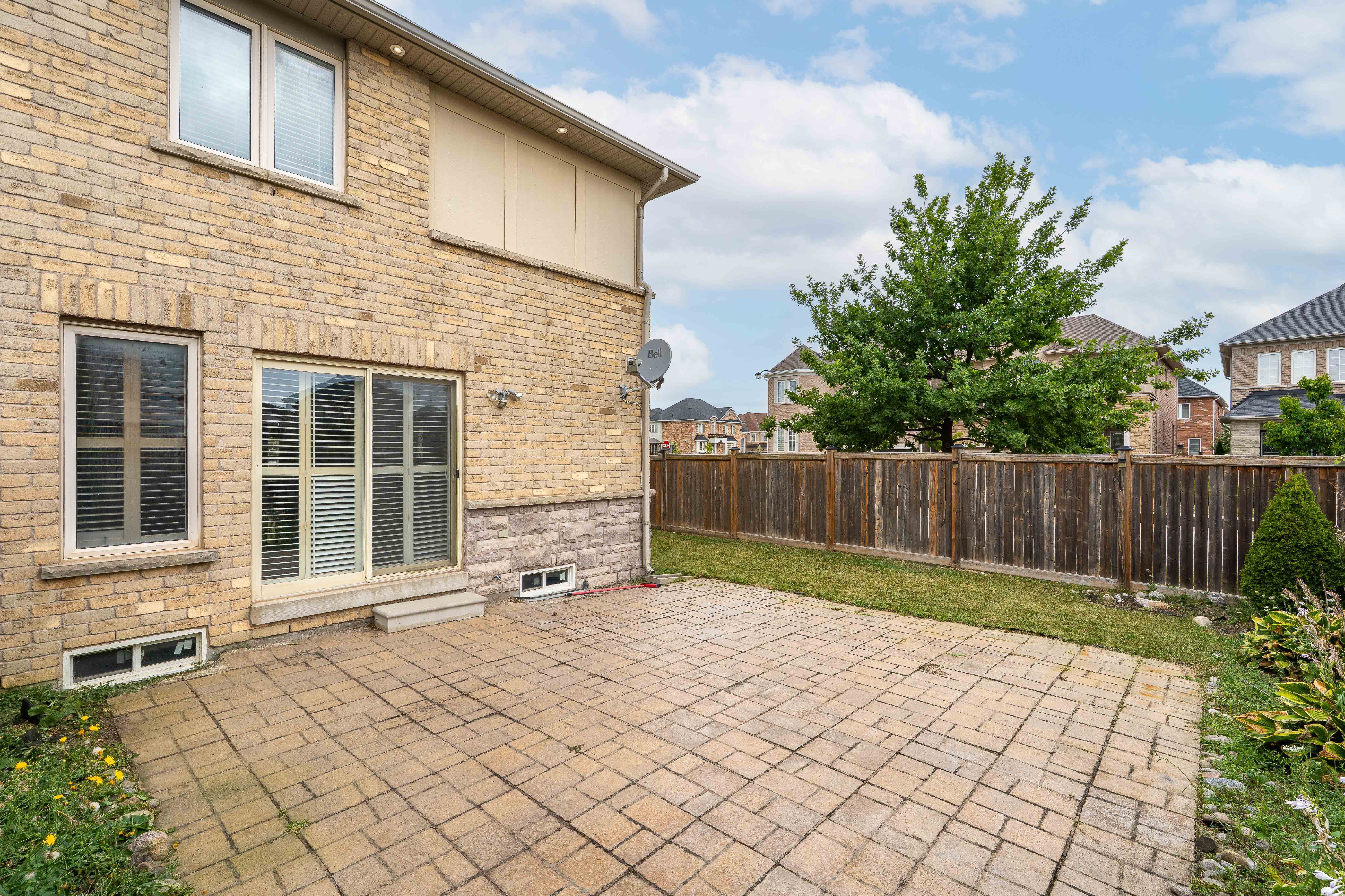 Backyard patio and fenced yard